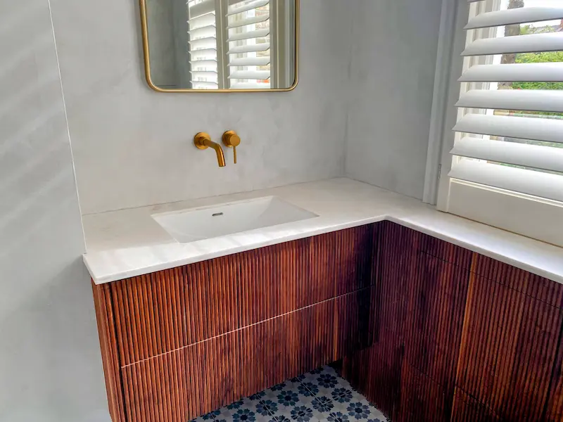Luxury bathroom featuring walnut vanity cabinet and modern basin